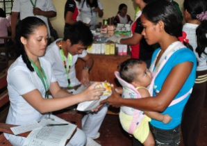 A mother receives vitamins and medicines for her baby during a medical outreach of the provincial government of Davao del Norte. nobags